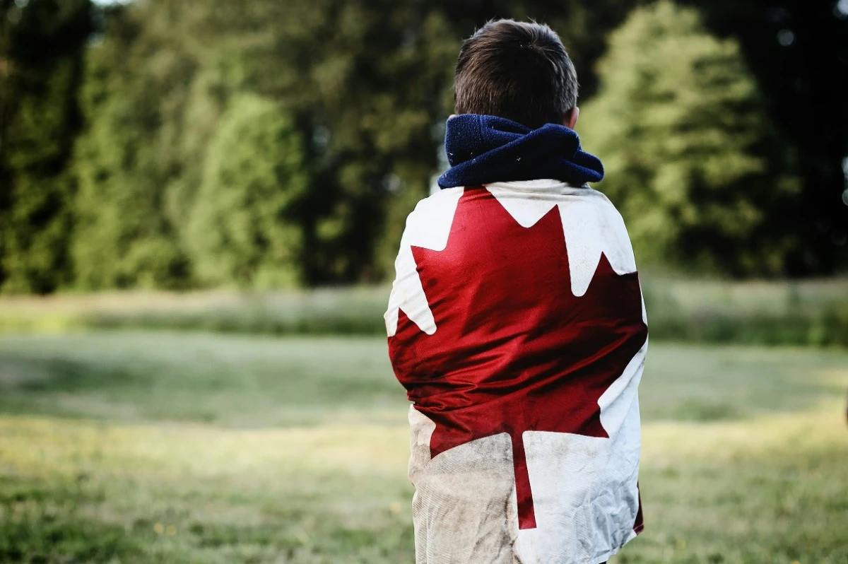 boy wrapped in canada flag